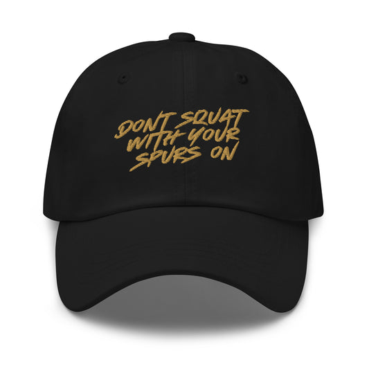 Keep it cowboy, keep it wild. This black cap features the iconic warning: Don’t squat with your spurs on. Built for rebels, riders, and those who know better.